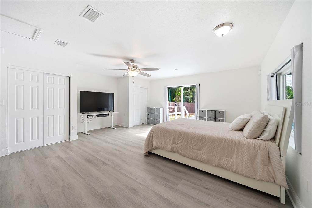 4988 Clarcona Ocoee Road Orlando, FL 32810 - Photo 14 of 48 a bedroom with a bed and a flat screen tv
