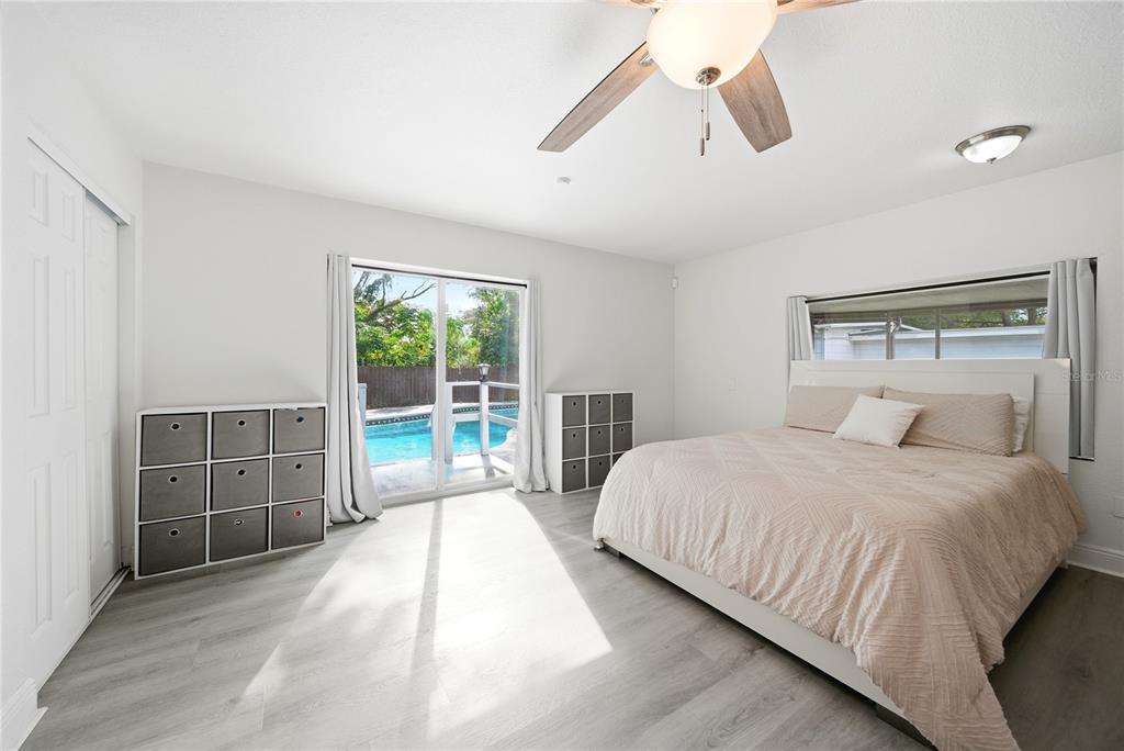 4988 Clarcona Ocoee Road Orlando, FL 32810 - Photo 15 of 48 a bedroom with a large bed and a window