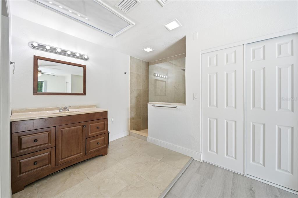 4988 Clarcona Ocoee Road Orlando, FL 32810 - Photo 18 of 48 a spacious bathroom with a double vanity sink and a mirror