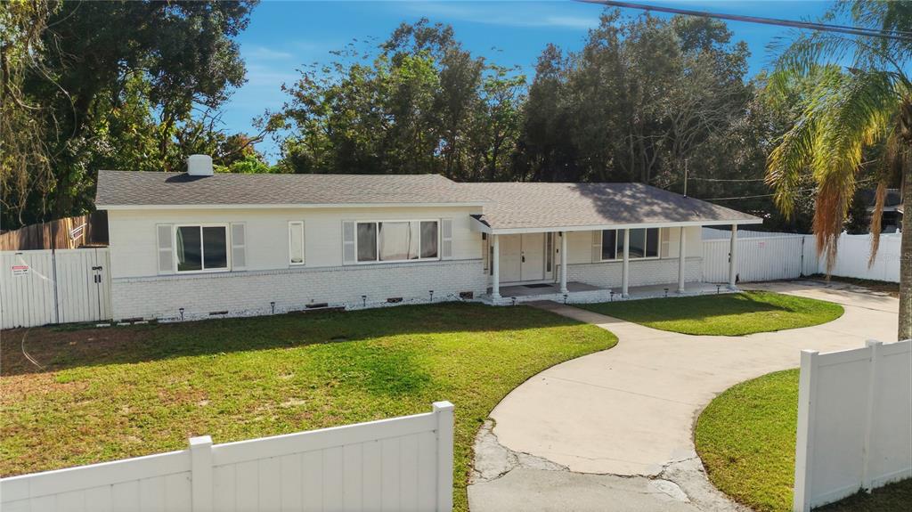 4988 Clarcona Ocoee Road Orlando, FL 32810 - Photo 2 of 48 a view of a house with swimming pool and a yard