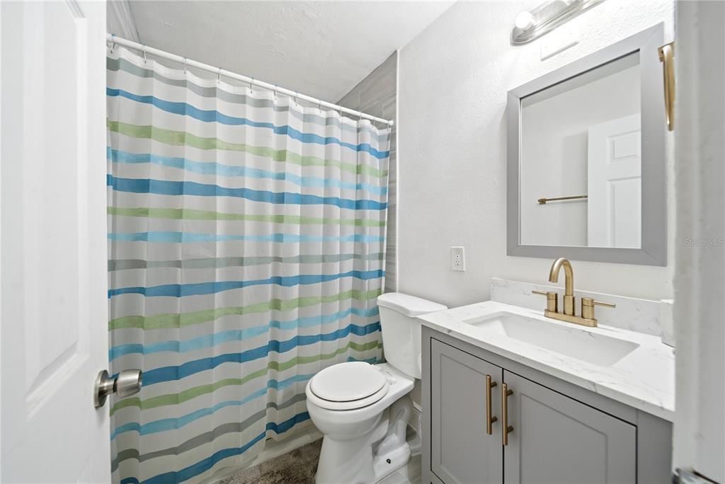 4988 Clarcona Ocoee Road Orlando, FL 32810 - Photo 22 of 48 a bathroom with a sink and a mirror