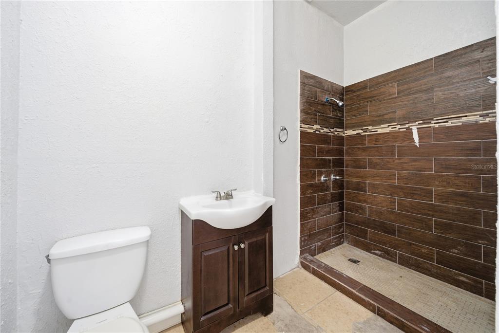 4988 Clarcona Ocoee Road Orlando, FL 32810 - Photo 28 of 48 a bathroom with a toilet a sink and shower