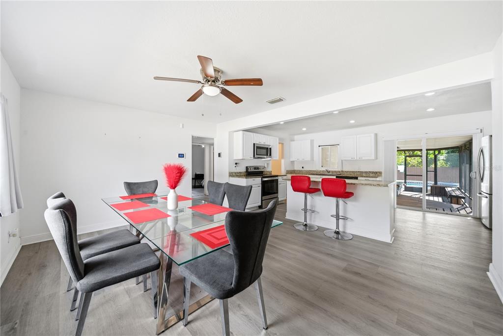 4988 Clarcona Ocoee Road Orlando, FL 32810 - Photo 6 of 48 a living room with furniture and kitchen view