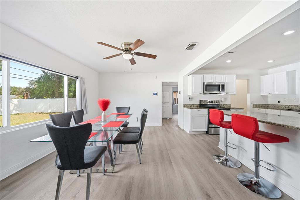 4988 Clarcona Ocoee Road Orlando, FL 32810 - Photo 8 of 48 a living room with furniture and kitchen view