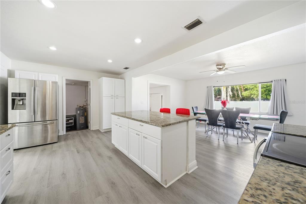 4988 Clarcona Ocoee Road Orlando, FL 32810 - Photo 9 of 48 a living room with furniture and a kitchen view