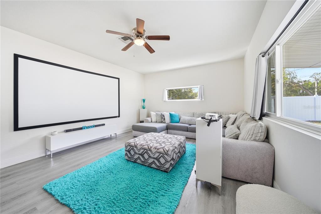 4988 Clarcona Ocoee Road Orlando, FL 32810 - Photo 10 of 48 a living room with furniture and a flat screen tv