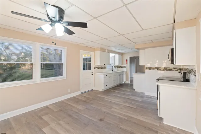 a kitchen with refrigerator and cabinets