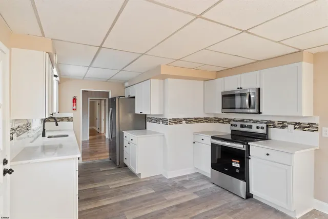 a kitchen with a stove a sink and a refrigerator