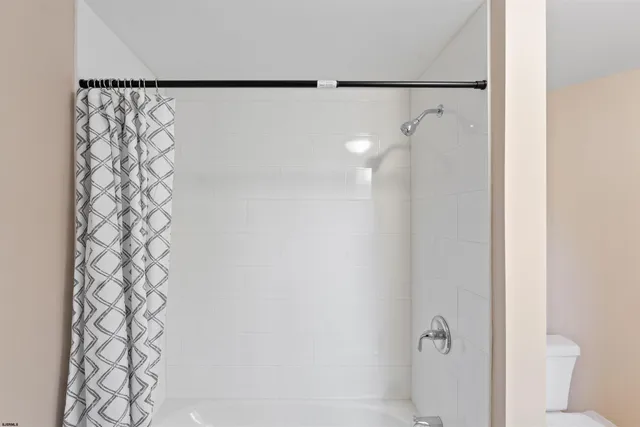 a view of empty room with wooden floor and fireplace