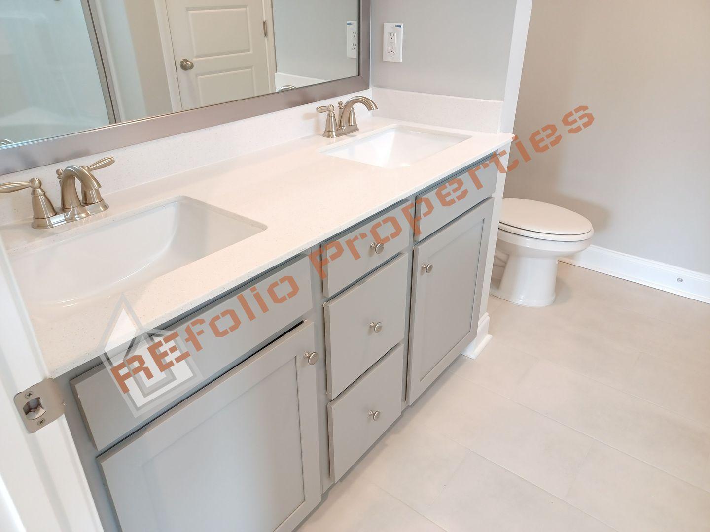 184 Howards Crossing Drive Wendell, NC 27591 - Photo 12 of 29 a close view of a sink and a toilet