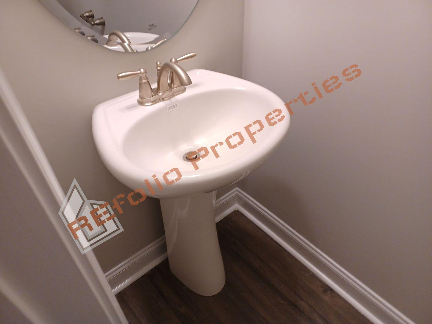 184 Howards Crossing Drive Wendell, NC 27591 - Photo 14 of 29 a bathroom with a sink and mirror