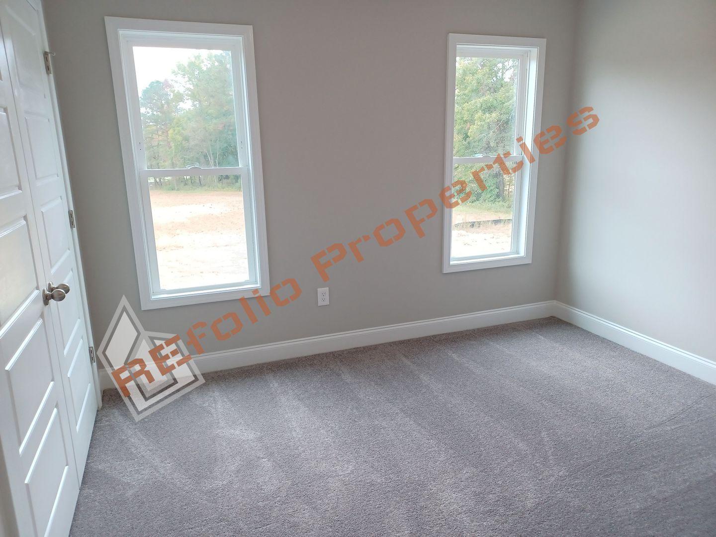 184 Howards Crossing Drive Wendell, NC 27591 - Photo 17 of 29 an empty room with windows