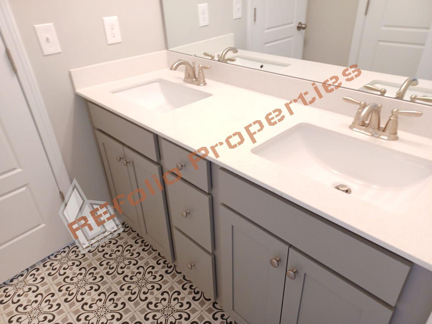 184 Howards Crossing Drive Wendell, NC 27591 - Photo 19 of 29 a bathroom with a sink and a mirror