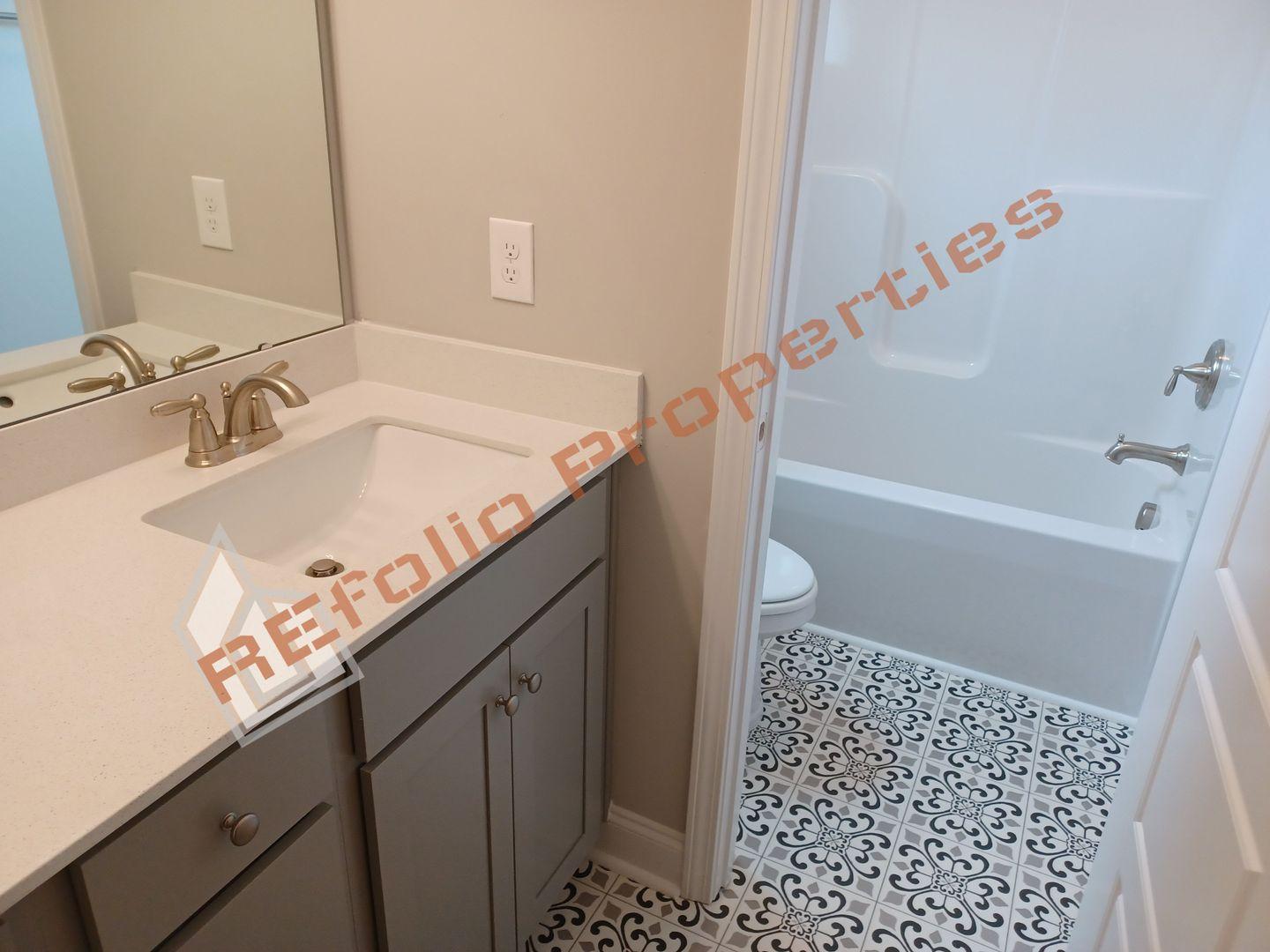 184 Howards Crossing Drive Wendell, NC 27591 - Photo 20 of 29 a bathroom with a sink a toilet and shower