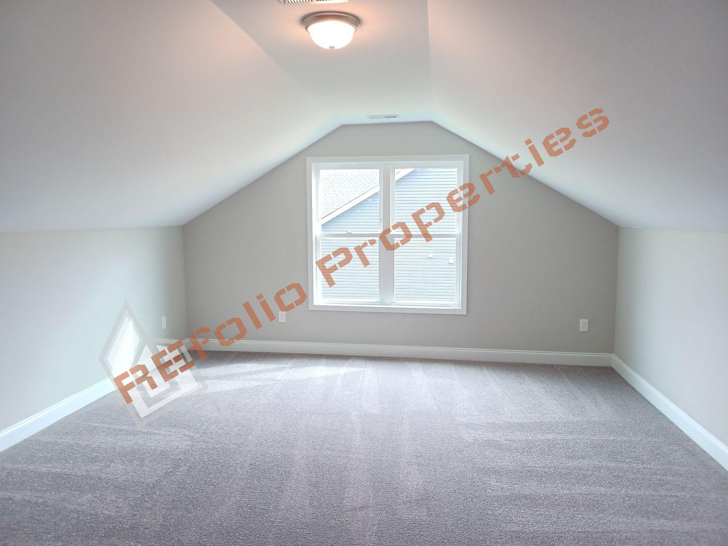 184 Howards Crossing Drive Wendell, NC 27591 - Photo 21 of 29 an empty room with windows