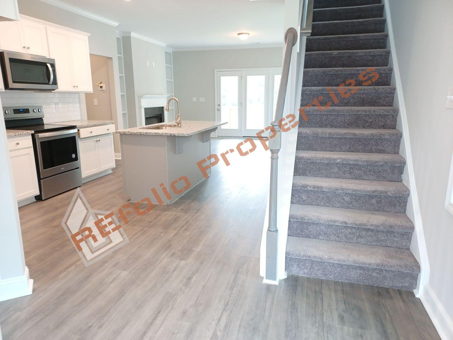 184 Howards Crossing Drive Wendell, NC 27591 - Photo 3 of 29 a view of entryway and hall with wooden floor