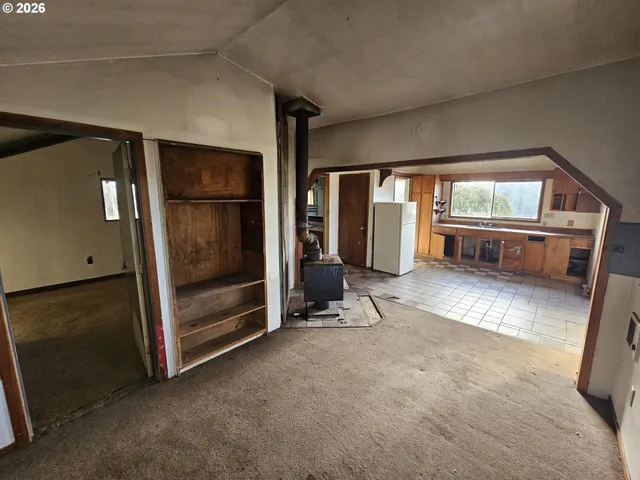 a view of an empty room with a fireplace