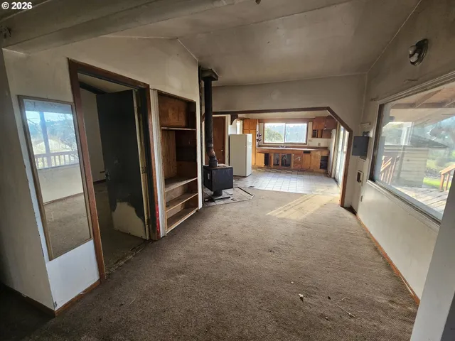 a view of a hallway with furniture and a window