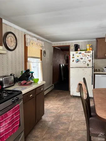 a kitchen with stainless steel appliances granite countertop a refrigerator and a stove top oven