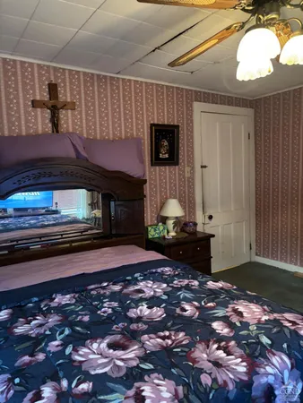 a bedroom with bed and a window