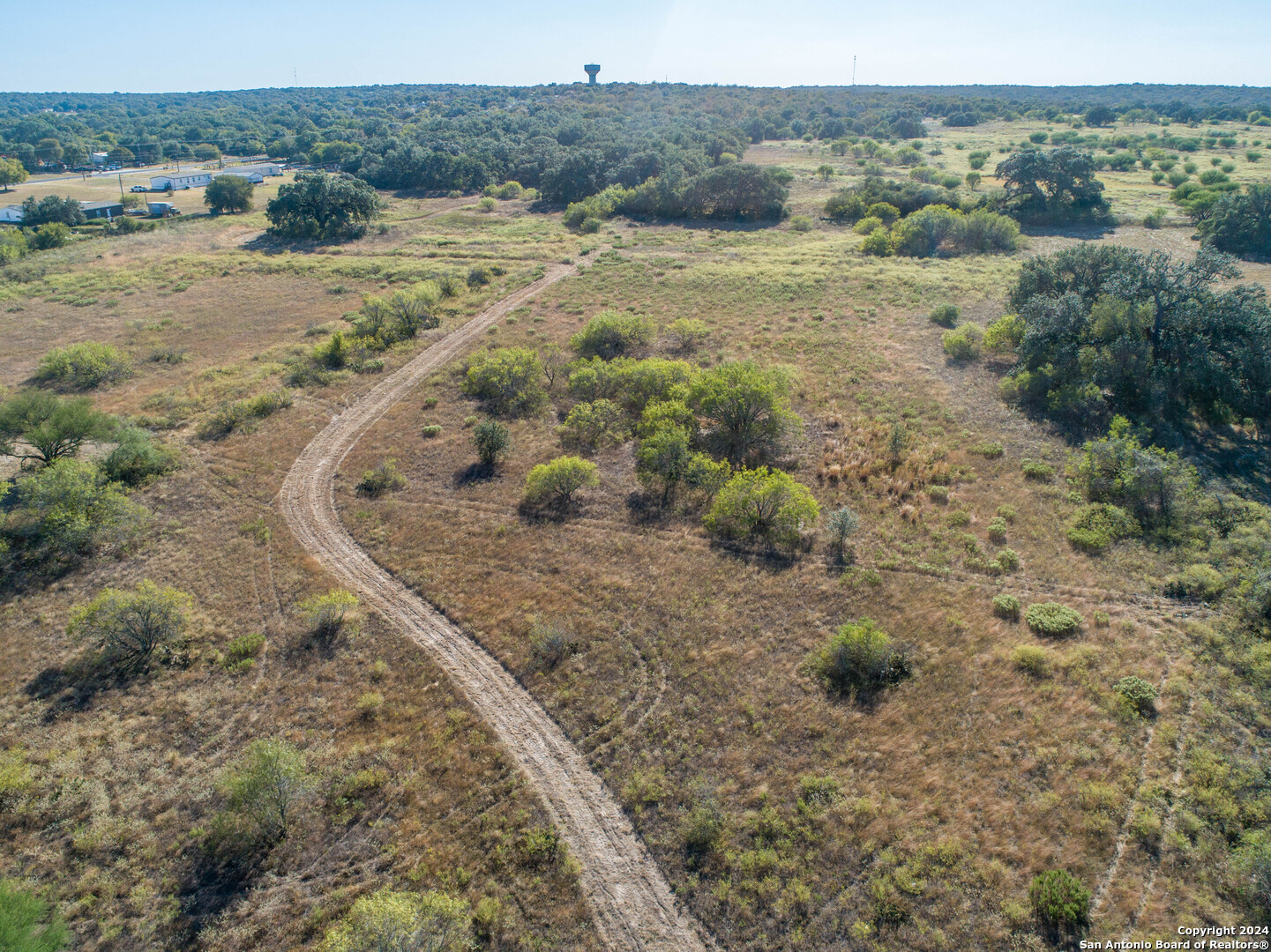 21123 Lamm Road Elmendorf, TX 78112 - Photo 3 of 45 a view of a lake with beach and city view
