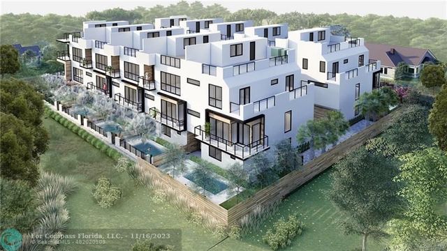 an aerial view of residential houses with outdoor space and river