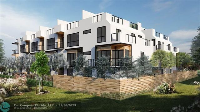 a front view of a residential apartment building with a yard