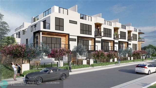 a view of a street that has couple of cars parked on the road