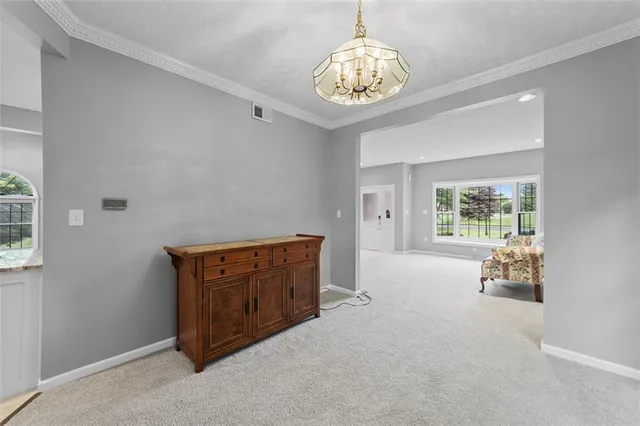 a dining room with wooden floor and a rug