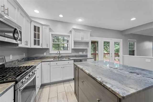 a view of an empty room with glass door and windows