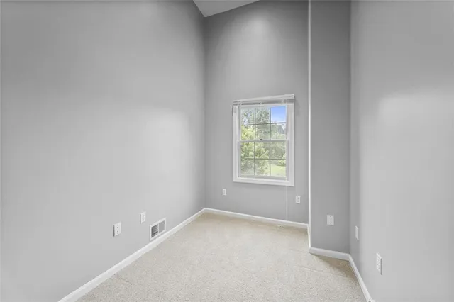 a view of staircase with railing and white walls