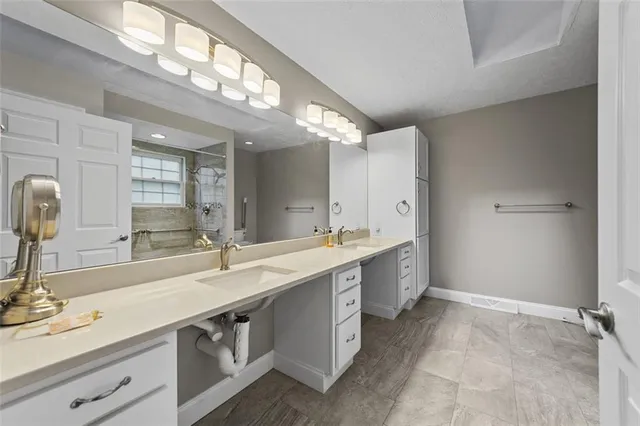 a kitchen with white cabinets and refrigerator