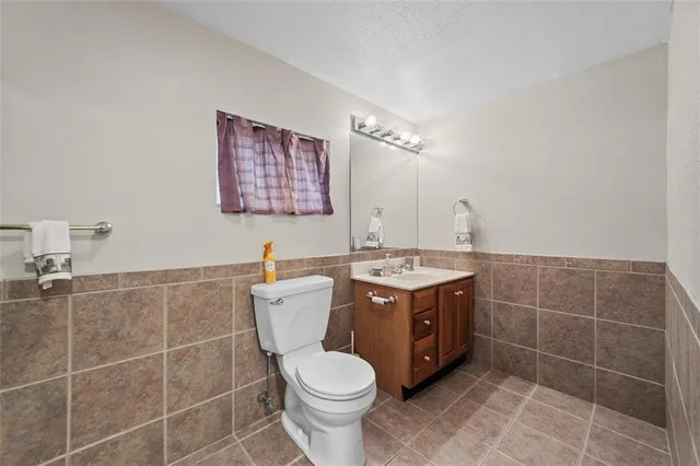 a bathroom with a toilet and shower