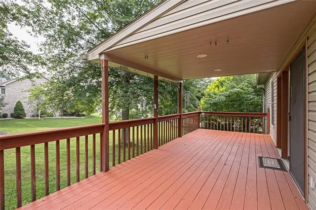 a view of balcony with wooden floor and fence
