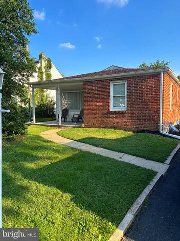 a view of a big house with a big yard and potted plants