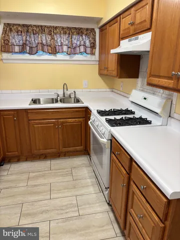a kitchen with stainless steel appliances granite countertop a stove and a sink