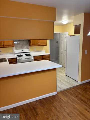 a kitchen with stainless steel appliances a stove a refrigerator and a cabinets