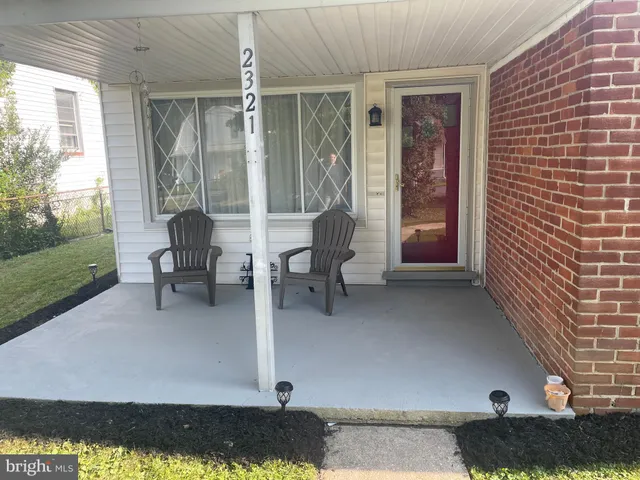 a building outdoor space with patio furniture and potted plants