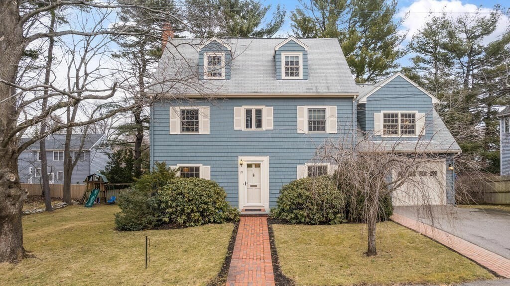 26 Virginia Road Needham, MA 02494 - Photo 1 of 41 a view of a brick house with large windows and a yard