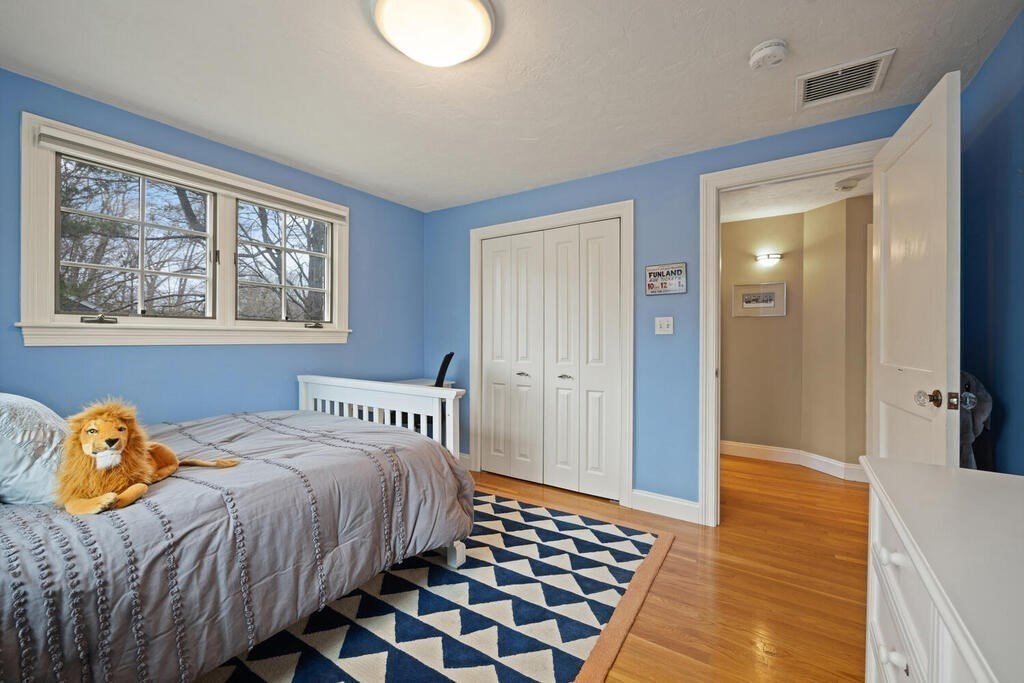 26 Virginia Road Needham, MA 02494 - Photo 24 of 41 a bedroom with a bed and wooden floor
