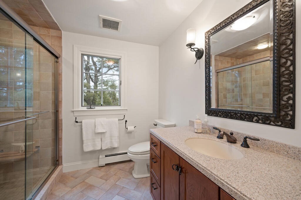 26 Virginia Road Needham, MA 02494 - Photo 29 of 41 a bathroom with a granite countertop sink toilet and shower