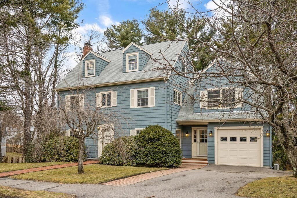 26 Virginia Road Needham, MA 02494 - Photo 3 of 41 a front view of a house with a yard and garage