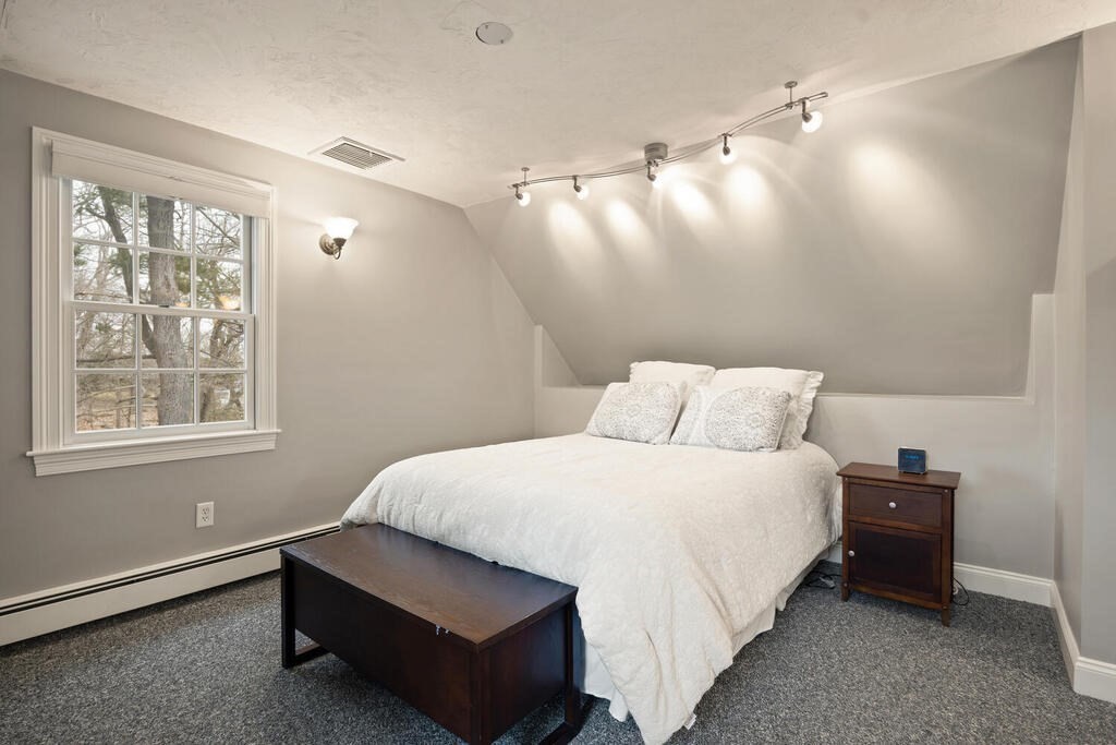 26 Virginia Road Needham, MA 02494 - Photo 31 of 41 a spacious bedroom with a bed and a window