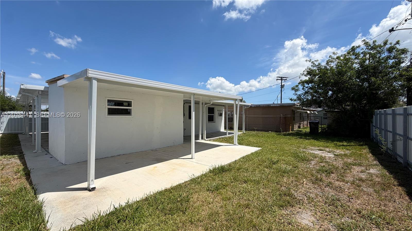 2230 Service Road Opa-Locka, FL 33054 - Photo 22 of 25 a front view of a house with a yard