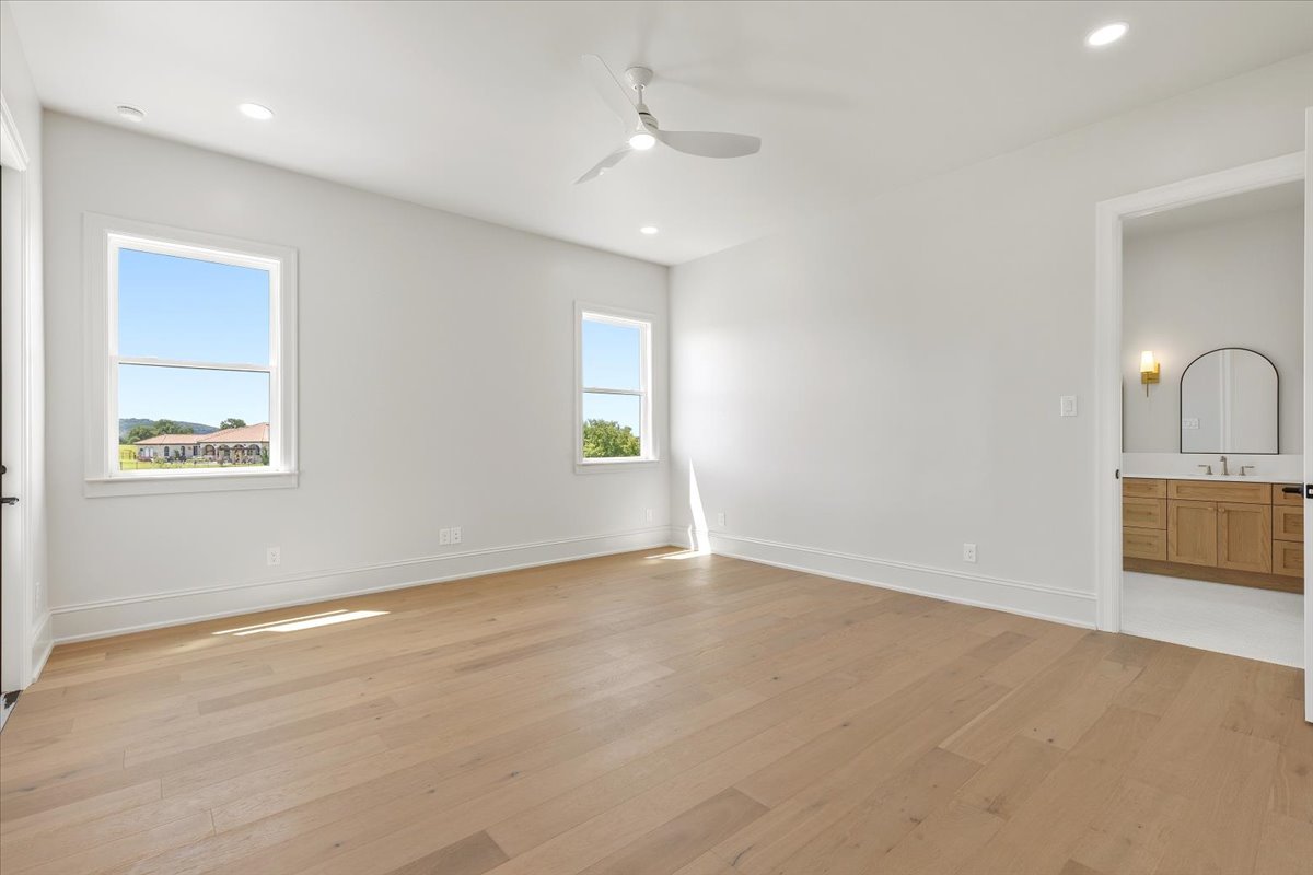224 Sandia Loop Kingsland, TX 78639 - Photo 15 of 32 wooden floor in an empty room with a window