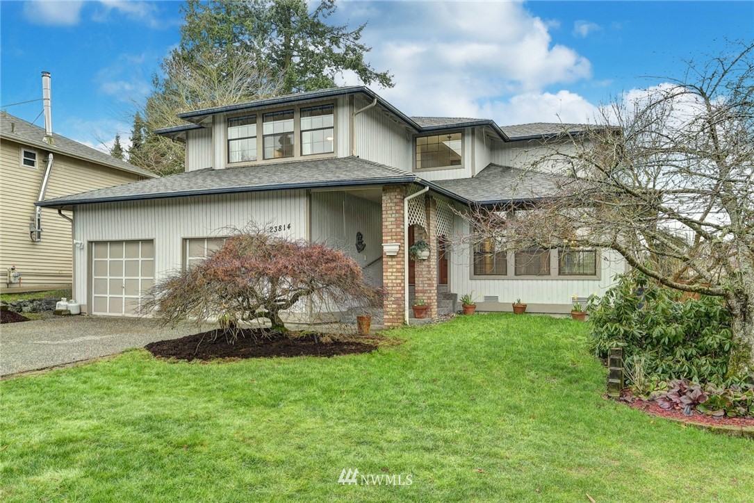23814 23rd Drive Southeast Bothell, WA 98021 - Photo 1 of 26 a front view of a house with a garden
