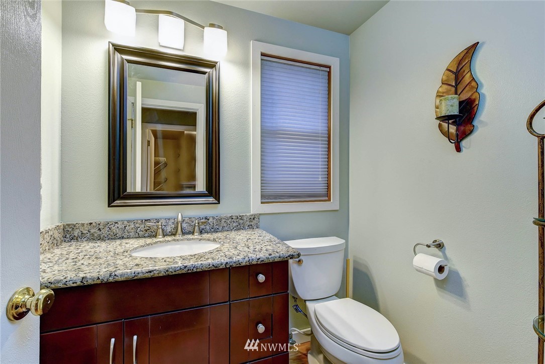 23814 23rd Drive Southeast Bothell, WA 98021 - Photo 11 of 26 a bathroom with a granite countertop toilet sink and mirror