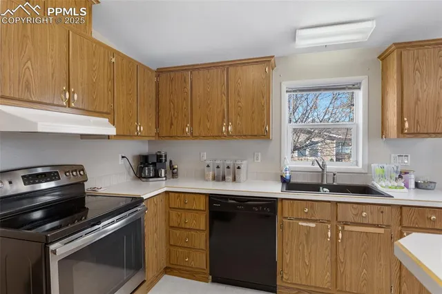 a kitchen with a sink stove top oven and cabinets