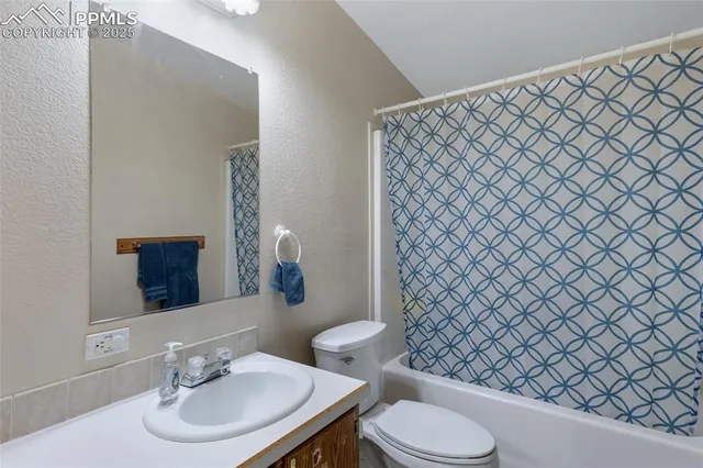 a bathroom with a sink and a mirror with toilet