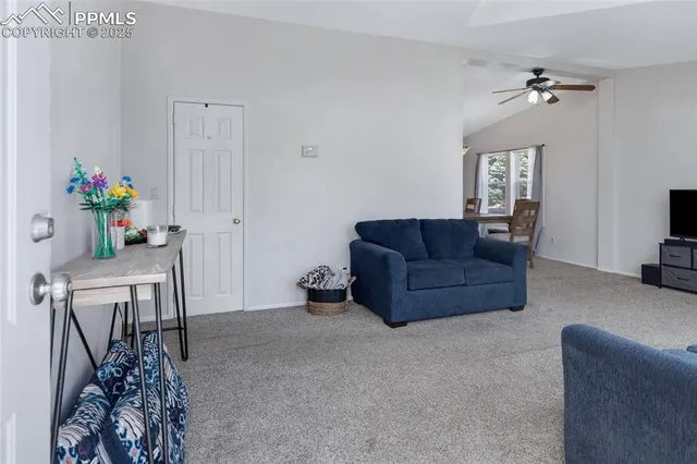 a living room with furniture and flowers